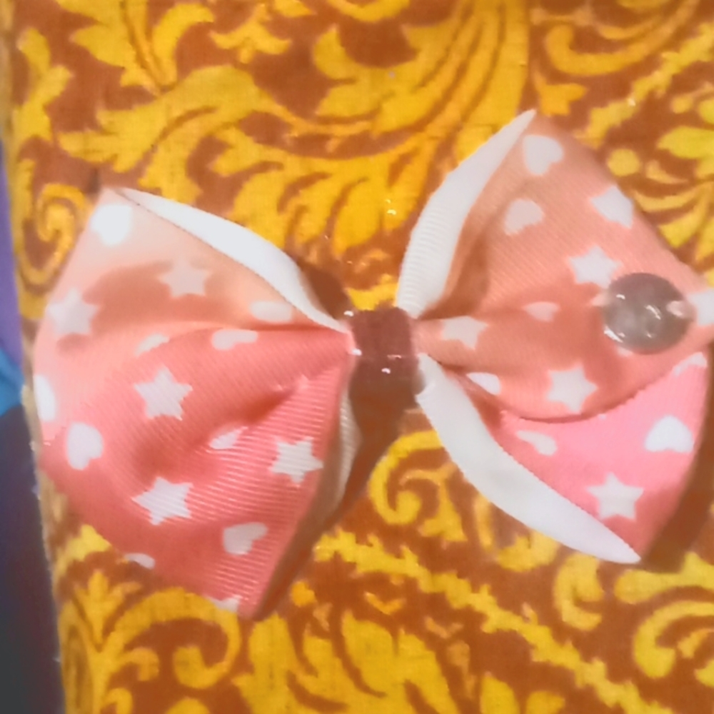 A pink Jojo siwa bow with hearts and stars in great condition